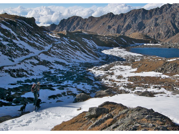 Trekking trail covered in snow along the Gosaikunda route with Himalayan peaks in the distance