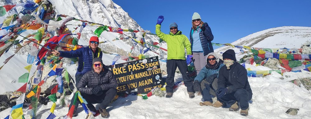 Trekkers at Larke Pass on the Manaslu Circuit Trek with views of snow-covered Himalayan peaks